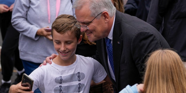 Australian Prime Minister Scott Morrison poses for a selfie after voting in his electorate of Cook in Sydney, Australia, Saturday, May 21, 2022. Australians go to the polls Saturday following a six-week election campaign that has focused on pandemic-fueled inflation, climate change and fears of a Chinese military outpost being established less than 1,200 miles off Australia's shore.