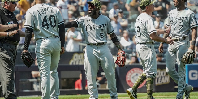 Umpires, left, call for calm while Chicago White Sox third base coach Joe McEwing (99), second from right, holds back White Sox shortstop Tim Anderson (7) during a game against the New York Yankees, Saturday, May 21, 2022, in New York. 