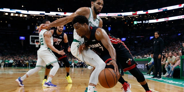 Miami Heat's Kyle Lowry drives past Celtics' Jayson Tatum during the Eastern Conference finals, May 21, 2022, in Boston. 
