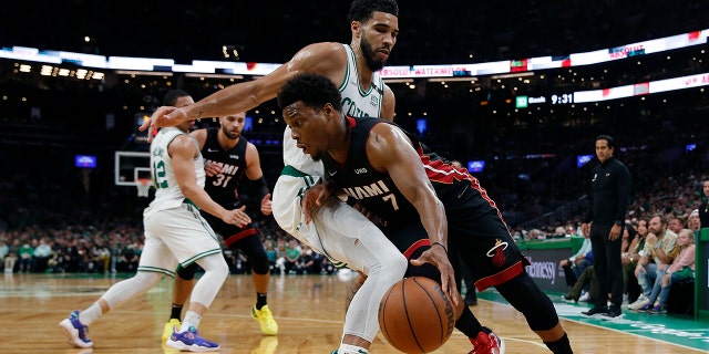 Miami Heat's Kyle Lowry drives past Celtics' Jayson Tatum during the Eastern Conference finals, May 21, 2022, in Boston. 