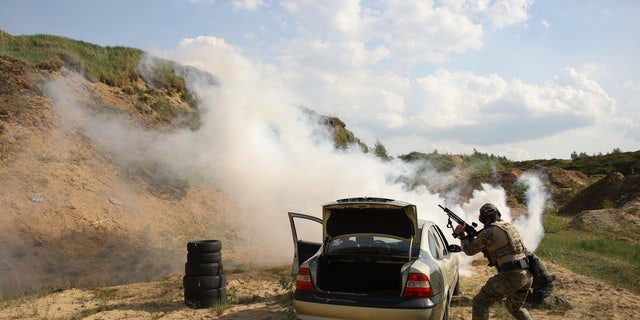 Volunteers from Belarus practice at a shooting range near Warsaw, Poland, on Friday, May 20, 2022. Belarusians are among the foreign fighters who have volunteered to take up arms in Ukraine against <a href=