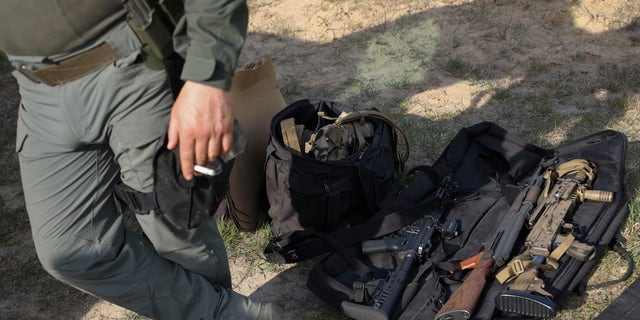 The weapons of volunteers from Belarus are placed on the ground as they take a break at a shooting range near Warsaw, Poland, Friday, May 20, 2022. Belarusians are among the foreign fighters who have volunteered to take up arms in Ukraine against Russian forces. They consider the Ukrainians defending their homeland to be their brethren. And by joining their resistance to Russia's onslaught, they hope to weaken the rule of Russian President Vladimir Putin, and ultimately that of Belarus President Alexander Lukashenko. 