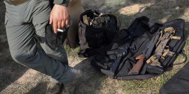 The weapons of volunteers from Belarus are placed on the ground as they take a break at a shooting range near Warsaw, Poland, Friday, May 20, 2022. Belarusians are among the foreign fighters who have volunteered to take up arms in Ukraine against Russian forces. They consider the Ukrainians defending their homeland to be their brethren. And by joining their resistance to Russia's onslaught, they hope to weaken the rule of Russian President Vladimir Putin, and ultimately that of Belarus President Alexander Lukashenko. 