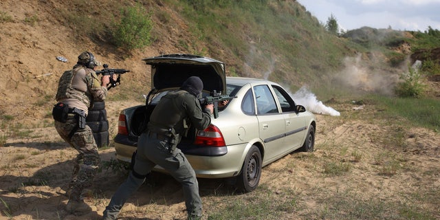 Volunteers from Belarus train at a shooting range near Warsaw, Poland, on Friday, May 20, 2022. The fighters from Belarus are improving their military skills in Poland before deploying to Ukraine, where they plan to join a legion of foreign fighters defending Ukraine against Russian attacks.