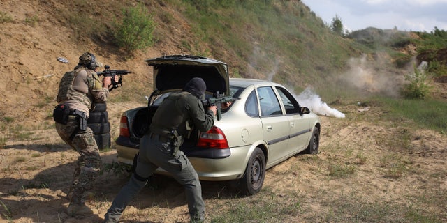 Volunteers from Belarus train at a shooting range near Warsaw, Poland, on Friday, May 20, 2022. The fighters from Belarus are improving their military skills in Poland before deploying to Ukraine, where they plan to join a legion of foreign fighters defending Ukraine against Russian attacks.
