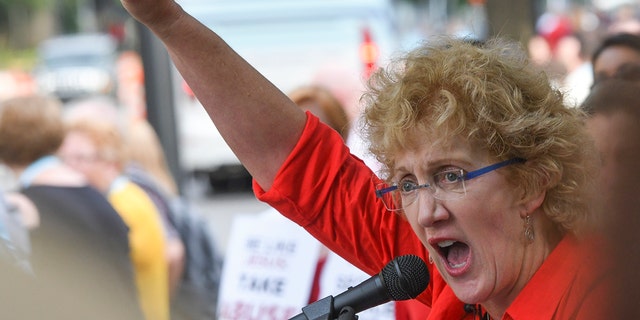 FILE - In this Tuesday, June 11, 2019 file photo, Christa Brown, of Denver, Colo., speaks during a rally in Birmingham, Ala., outside the Southern Baptist Convention's annual meeting. Brown, an author and retired attorney, says she was abused by a Southern Baptist minister as a child. After reading an investigative report released by the SBC on Sunday, May 22, 2022, Brown said it "fundamentally confirms what Southern Baptist clergy sex abuse survivors have been saying for decades. ... I view this investigative report as a beginning, not an end. The work will continue."