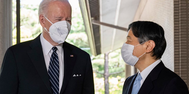 Japan's Emperor Naruhito, right, greets U.S. President Joe Biden prior to their meeting at the Imperial Palace in Tokyo Monday, May 23, 2022.