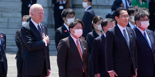 U.S. President Joe Biden, front, left, and Japan's Prime Minister Fumio Kishida, front right, listen to the national anthem at the Akasaka Palace state guest house in Tokyo, Japan, Monday, May 23, 2022.
