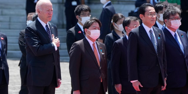 U.S. President Joe Biden, front, left, and Japan's Prime Minister Fumio Kishida, front right, listen to the national anthem at the Akasaka Palace state guest house in Tokyo, Japan, Monday, May 23, 2022.