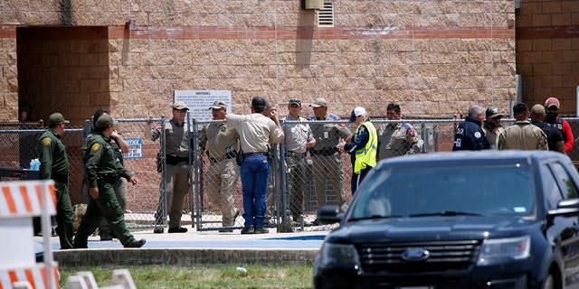 Law enforcement, and other first responders, gather outside Robb Elementary School following a shooting, Tuesday, May 24, 2022, in Uvalde, Texas. 