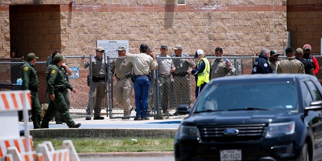 Law enforcement, and other first responders, gather outside Robb Elementary School following a shooting, Tuesday, May 24, 2022, in Uvalde, Texas.