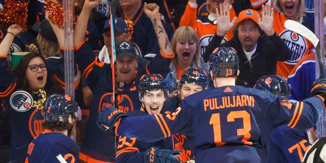 Edmonton Oilers center Ryan Nugent-Hopkins, second from left, celebrates his goal against the Calgary Flames with teammates during the first period of Game 4 of an NHL hockey Stanley Cup playoffs second-round series Tuesday, May 24, 2022, in Edmonton