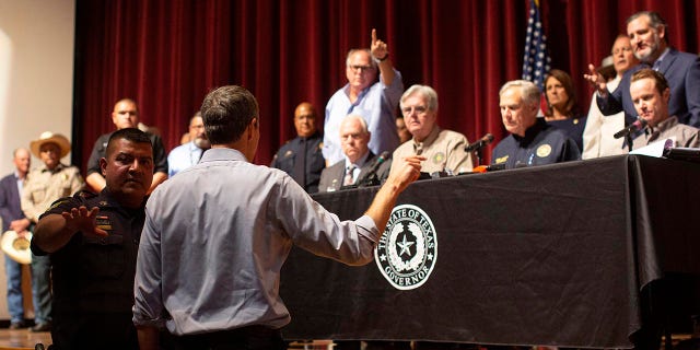 Democrat Beto O'Rourke, who is running against Texas Gov. Greg Abbott for governor this year, interrupts a news conference headed by Abbott in Uvalde, Texas Wednesday, May 25, 2022.
