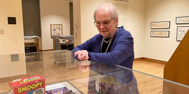 Lucy Shelton Caswell, founding curator of the Billy Ireland Cartoon Library Museum, examines memorabilia tied to the comic strip "Peanuts" 금요일에, 할 수있다 20, 2022, in Columbus, 오하이오.