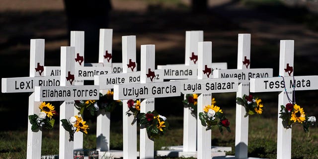 Crosses with the names of Tuesday's shooting victims are placed outside Robb Elementary School in Uvalde, Texas, Thursday, May 26, 2022. The 18-year-old man who slaughtered 19 children and two teachers in Texas left a digital trail that hinted at what was to come. 