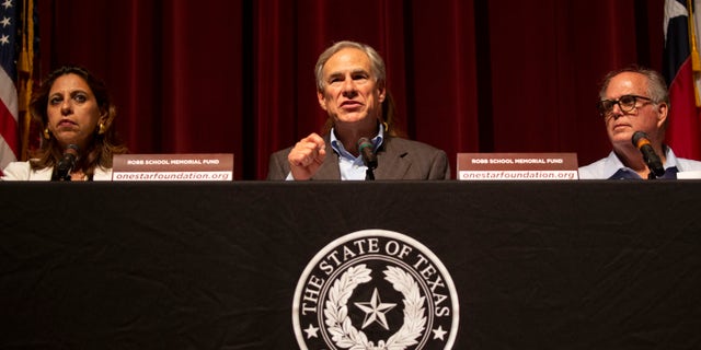 Texas Governor Greg Abbott, center, speaks during a news conference about the elementary school shooting with Uvalde Mayor Don McLaughlin, right and Texas District Attorney for the 38th Judicial District, Christina Mitchell Busby, Friday, May 27, 2022, in Ovaldi, Texas.