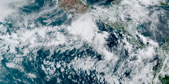 This satellite image made available by NOAA shows Hurricane Agatha, center, off the Pacific coast of Mexico on Sunday, May 29, 2022 at 11:20 a.m. EDT.  (NOAA via AP)