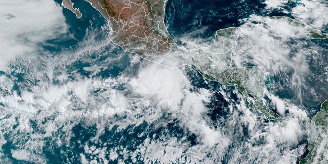 This satellite image made available by NOAA shows Hurricane Agatha, center, off the Pacific coast of Mexico on Sunday, May 29, 2022, at 11:20 a.m. EDT. (NOAA via AP)