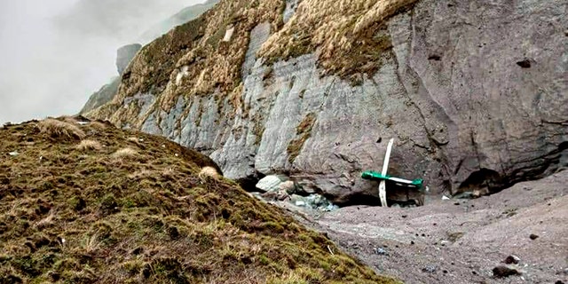 This handout photograph released by Fishtail Air, shows the wreckage of a plane in a gorge in Sanosware in Mustang district close to the mountain town of Jomsom, west of Kathmandu, Nepal, Monday, May 30, 2022. The wreckage of a plane carrying 22 people that disappeared in Nepal's mountains was found Monday scattered on a mountainside, the army said. There was no word on survivors. (Fishtail Air via AP)