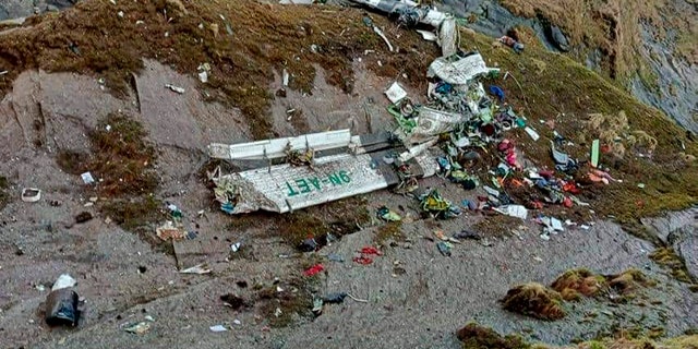 This handout photograph released by Fishtail Air, shows the wreckage of a plane in a gorge in Sanosware in Mustang district close to the mountain town of Jomsom, west of Kathmandu, Nepal, Monday, May 30, 2022. The wreckage of a plane carrying 22 people that disappeared in Nepal's mountains was found Monday scattered on a mountainside, the army said. There was no word on survivors. (Fishtail Air via AP)