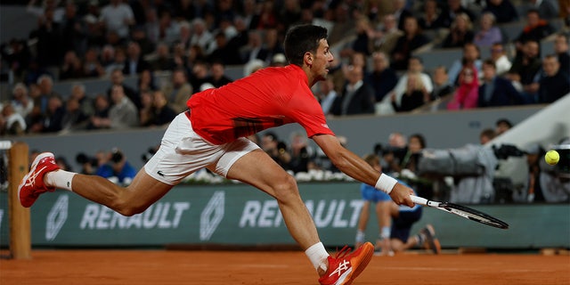 Serbia's Novak Djokovic tries to return the ball to Spain's Rafael Nadal during their quarterfinal match of the French Open tennis tournament at the Roland Garros stadium Tuesday, May 31, 2022, in Paris. 