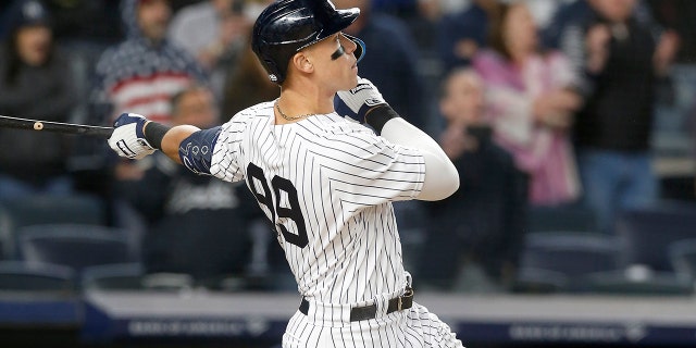 Aaron Judge #99 of the New York Yankees follows through on his ninth inning game winning three run home run against the Toronto Blue Jays at Yankee Stadium on May 10, 2022 in New York City. The Yankees defeated the Blue Jays 6-5.