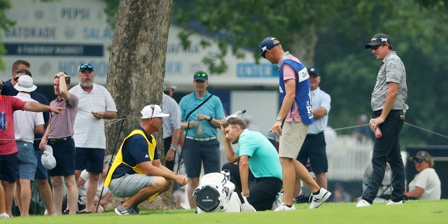 Aaron Wise reacts after being hit by a ball played by Cameron Smith during the second round of the 2022 PGA Championship at Southern Hills Country Club May 20, 2022, in Tulsa, Okla.