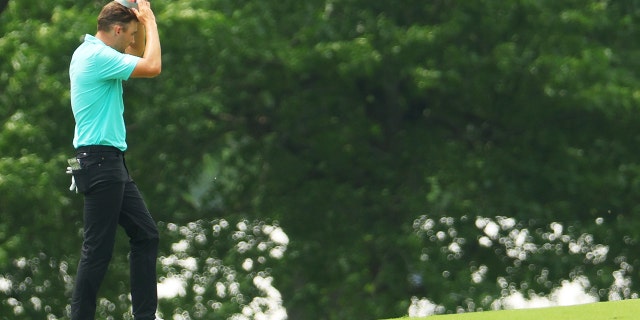 Aaron Wise of the U.S. reacts on the seventh hole after being hit by a ball from Cameron Smith of Australia during the second round of the 2022 PGA Championship at Southern Hills Country Club May 20, 2022, in Tulsa, Okla.