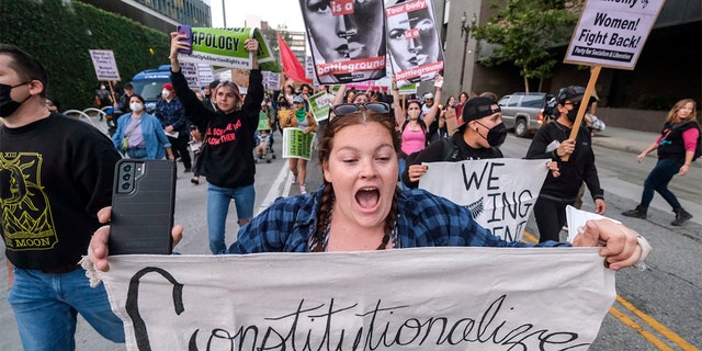 Demonstrators march down the streets after protesting outside of the U.S. Courthouse in response to a leaked draft of the Supreme Court's opinion to overturn Roe v. Wade, in Los Angeles, Tuesday, March 3, 2022. (AP Photo/Ringo H.W. Chiu)