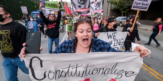 Demonstrators march down the streets after protesting outside of the U.S. Courthouse in response to a leaked draft of the Supreme Court's opinion to overturn Roe v. Wade, in Los Angeles, Tuesday, March 3, 2022. (AP Photo/Ringo H.W. Chiu)