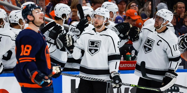 Los Angeles Kings Adrian Kempe, center, celebrates his goal with teammates as Edmonton Oilers left wing Zach Hyman looks away during the second period of Game 5 of an NHL hockey Stanley Cup first-round playoff series, Tuesday, May 10, 2022 in Edmonton, Alberta.