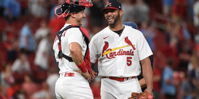 St. Louis Cardinals catcher Andrew Knizner (7) and teammate Albert Pujols celebrate their team's 15-6 victory over the San Francisco Giants after a baseball game on Sunday, May 15, 2022, in St. Louis.
