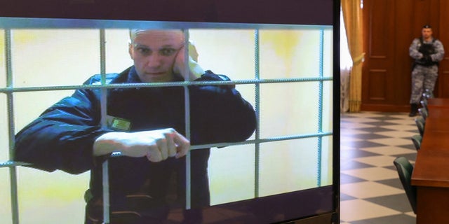 Russian opposition leader Alexei Navalny is seen on a screen via a video link from the IK-2 corrective penal colony in Pokrov during a court hearing to consider an appeal against his prison sentence in Moscow, Russia, on Tuesday, May 24.