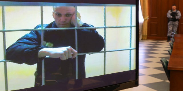 Russian opposition leader Alexei Navalny is seen on a screen via a video link from the IK-2 corrective penal colony in Pokrov during a court hearing to consider an appeal against his prison sentence in Moscow, Russia, on Tuesday, May 24.