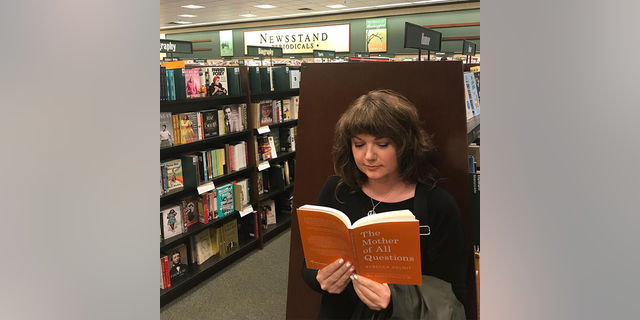 Amanda Page is shown reading "The Mother of All Questions" by Rebecca Solnit at a Barnes and Noble book store. (Amanda Page)