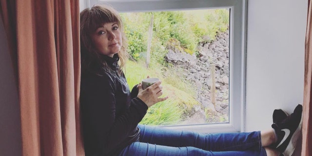 Ohio writer and teacher Amanda Page poses with a cup of tea on a windowsill in Scotland during a vacation. (Amanda Page)