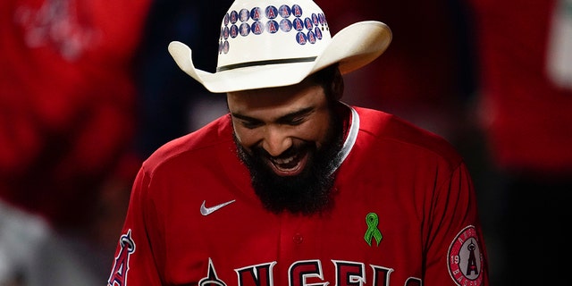 Los Angeles Angels' Anthony Rendon celebrates in the dugout after hitting a home run against the Tampa Bay Rays in Anaheim, California, Tuesday, May 10, 2022.