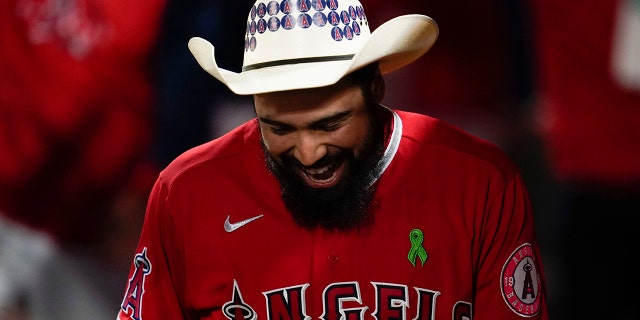 Los Angeles Angels' Anthony Rendon celebrates in the dugout after hitting a home run against the Tampa Bay Rays in Anaheim, California, Tuesday, May 10, 2022.