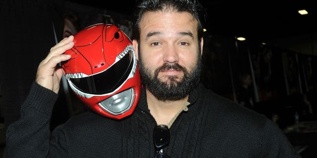 Austin St. John has been charged with COVID-19 aid fraud.