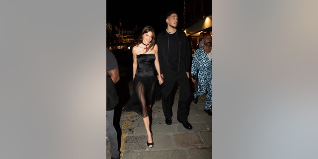 Kendall Jenner is accompanied by her NBA star boyfriend Devin Booker as they arrive to dinner in Italy.