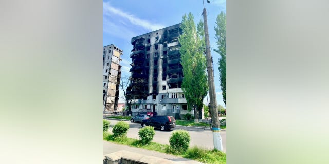 A nine-story apartment building is now two separate buildings, the middle part completely demolished by Russian bombs