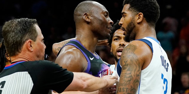 Referee David Guthrie tries to separate the Suns' Bismack Biyombo and Dallas Mavericks' Marquese Chriss during the semifinals Tuesday, May 10, 2022, in Phoenix.
