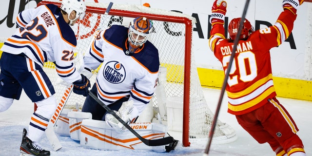 Edmonton Oilers goalie Mikko Koskinen, center, reacts as Calgary Flames forward Blake Coleman celebrates his goal during the second period of Game 1 of an NHL hockey second-round playoff series Wednesday, May 18, 2022, in Calgary, Alberta.