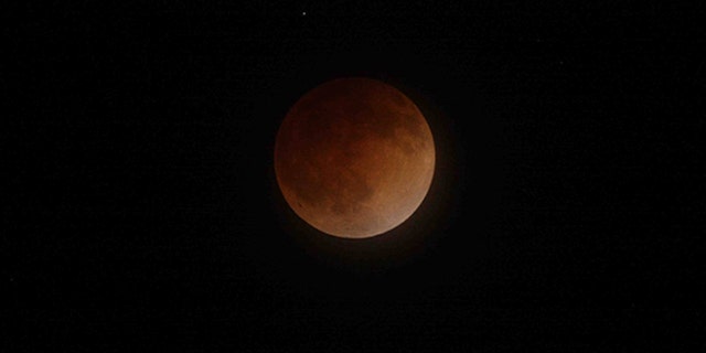 A blood moon against the night sky in 2014