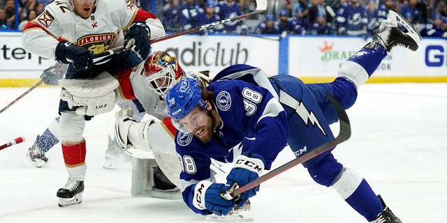 Tampa Bay Lightning left wing Brandon Hagel (38) goes down after crashing into Florida Panthers goaltender Sergei Bobrovsky (72) and defenseman Gustav Forsling (42) during the second period in Game 3 of an NHL hockey second-round playoff series Sunday, May 22, 2022, in Tampa, Fla. 