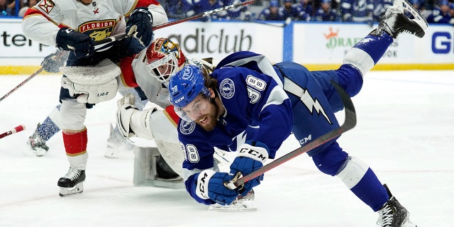 Tampa Bay Lightning's left winger Brandon Hagel (38) crashed after hitting Florida Panthers goalkeeper Sergei Bobrovsky (72) and defender Gustav Forsling (42) during the second period of the 3rd round of hockey playoffs. The NHL on Sunday, May 22nd. , 2022, in Tampa, Florida.