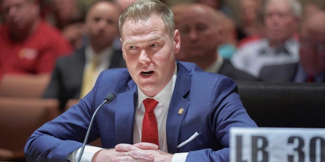 FILE - Nebraska state Sen. Brett Lindstrom of Omaha introduces speaks in Lincoln, Neb., Wednesday, Feb. 27, 2019. In Nebraska, the winner of a crowded Republican primary race for governor will be the overwhelming favorite to win in November 2022. (AP Photo/Nati Harnik, File)