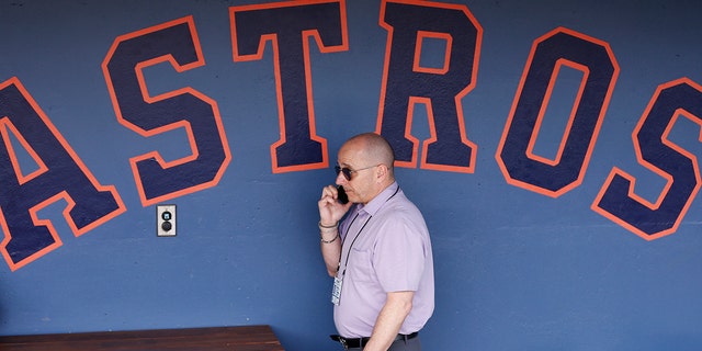 New York Yankees general manager Brian Cashman talks on the phone prior to a Grapefruit League spring training game between the Washington Nationals and the New York Yankees at FITTEAM Ballpark of The Palm Beaches March 12, 2020, in West Palm Beach, Fla.