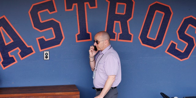 New York Yankees general manager Brian Cashman talks on the phone prior to a Grapefruit League spring training game between the Washington Nationals and the New York Yankees at FITTEAM Ballpark of The Palm Beaches March 12, 2020, in West Palm Beach, Fla.