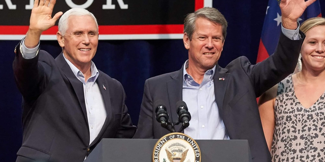 FILE - Former Vice President Mike Pence and Georgia Gov. Brian Kemp team up on the campaign trail in Dalton, Georgia in November 2018.
